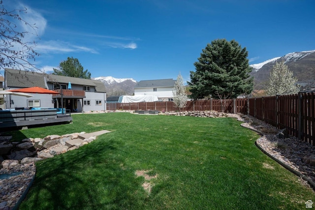 view of yard with a deck with mountain view