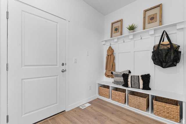 mudroom featuring light wood-type flooring and baseboards
