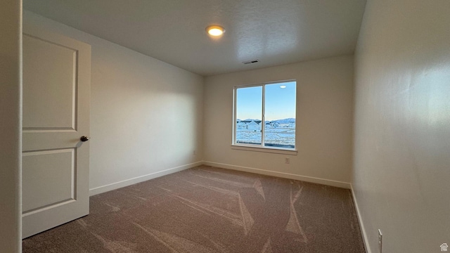 empty room with carpet flooring and baseboards