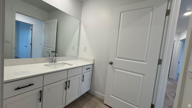 bathroom featuring vanity, baseboards, and tile patterned flooring