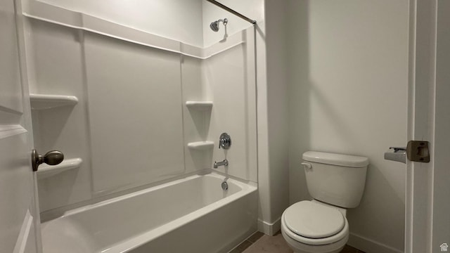 bathroom featuring toilet, baseboards, tub / shower combination, and tile patterned floors