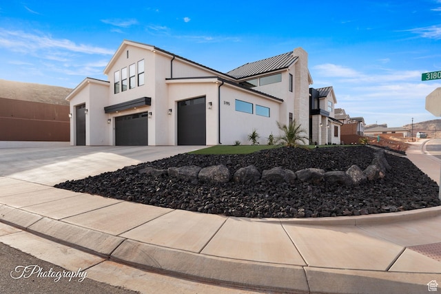 3195 S Tallow Tree Dr, St George, UT 84790 - view of front of property with concrete driveway, stucco siding, an attached garage, and a residential view