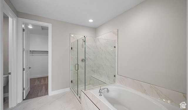 bathroom with a bath, a marble finish shower, marble finish floors, baseboards, and a walk in closet