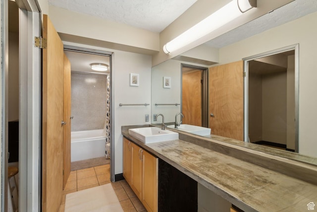 131 E 1st Ave N Unit 305, Salt Lake City, UT 84103 - bathroom featuring tile patterned floors, vanity, shower / bathtub combination with curtain, and a textured ceiling