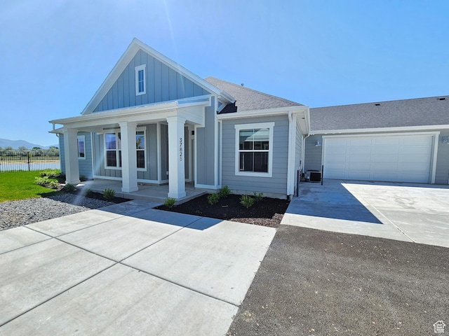 3782 S 4250 W Unit 432B, West Haven, UT 84401 - view of front of property featuring board and batten siding, driveway, a porch, fence, and a water view