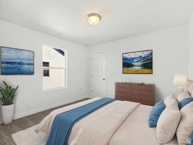 bedroom featuring carpet floors and baseboards
