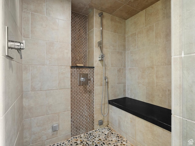 bathroom with a tile shower