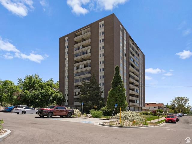 view of building exterior featuring uncovered parking