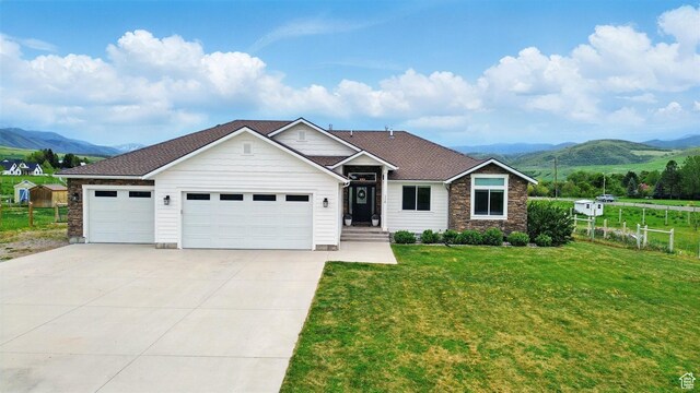 114 E 9500 S, Paradise, UT 84328 - view of front facade with a mountain view, a garage, concrete driveway, and stone siding