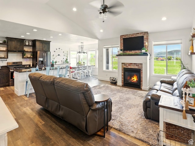 114 E 9500 S, Paradise, UT 84328 - living room featuring a ceiling fan, dark wood-type flooring, vaulted ceiling, a fireplace, and recessed lighting