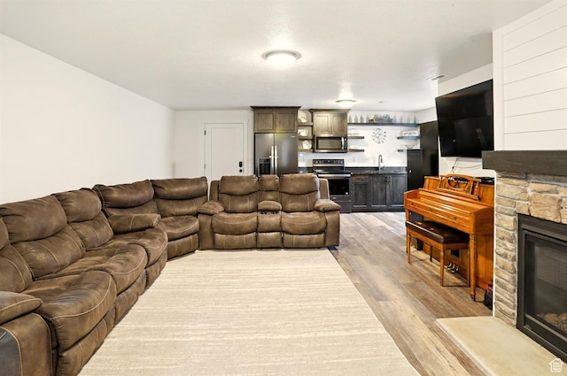 114 E 9500 S, Paradise, UT 84328 - living room with a fireplace, wet bar, and light wood-style flooring