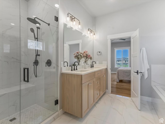 ensuite bathroom featuring a shower stall, baseboards, and marble finish flooring
