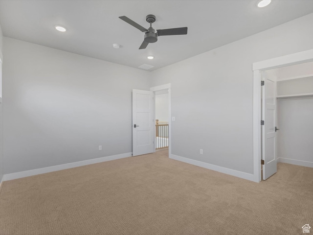 unfurnished bedroom featuring light carpet, baseboards, recessed lighting, and ceiling fan