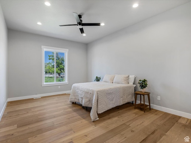 bedroom featuring baseboards, light wood-type flooring, recessed lighting, and ceiling fan