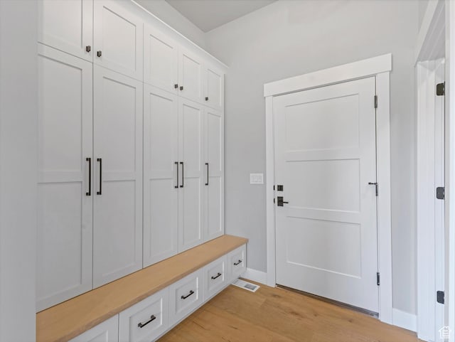 mudroom featuring light wood-type flooring and baseboards