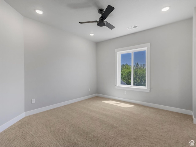 spare room with light colored carpet, baseboards, ceiling fan, and recessed lighting