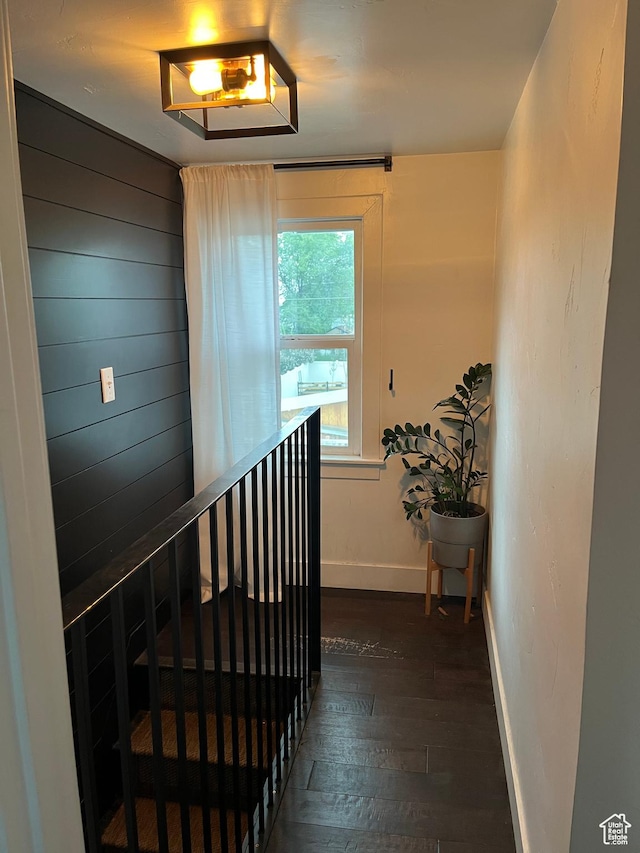 staircase with hardwood / wood-style floors and baseboards