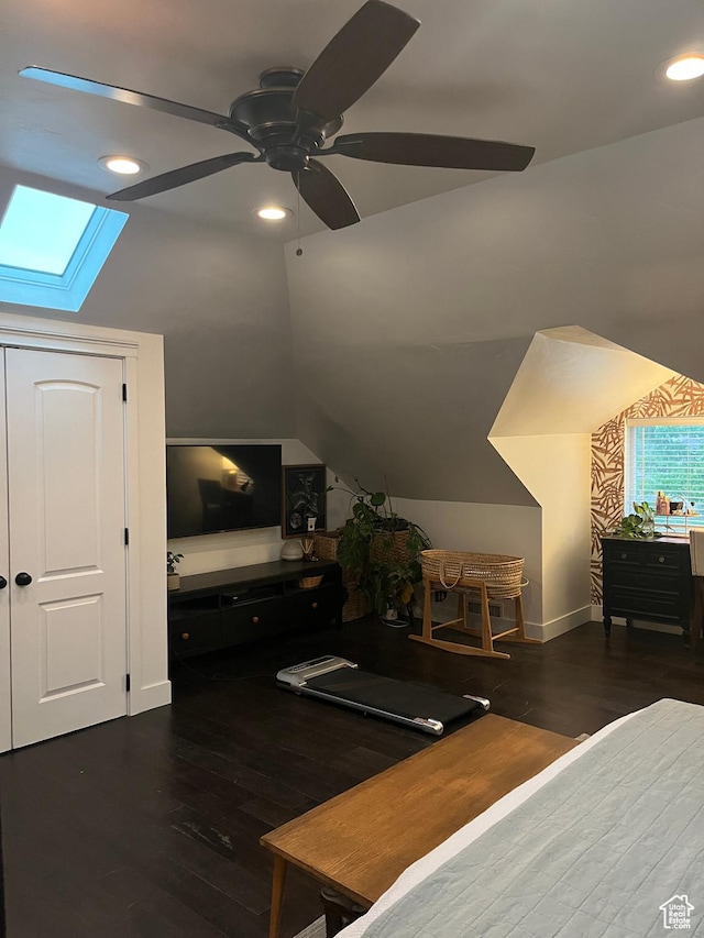 bedroom featuring a skylight, recessed lighting, wood finished floors, ceiling fan, and baseboards