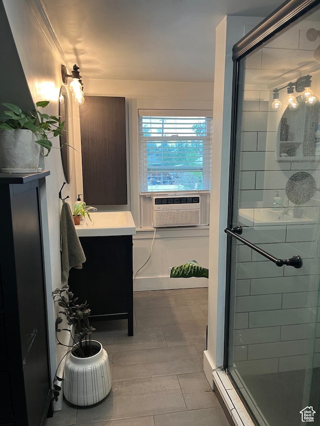 full bathroom featuring a stall shower, cooling unit, wood finished floors, and vanity