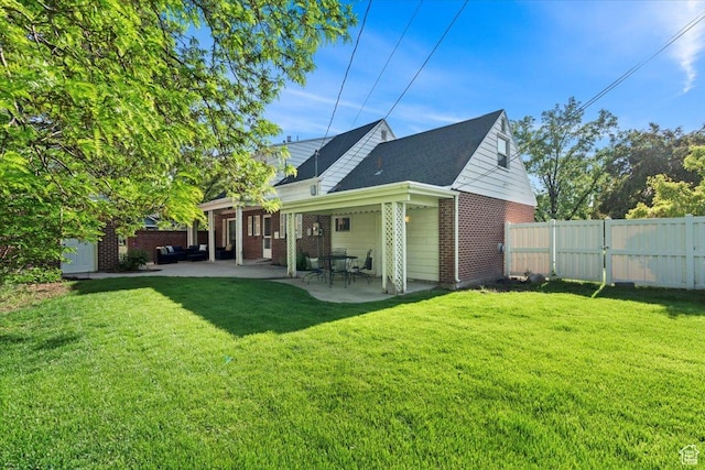 rear view of property with brick siding and a patio