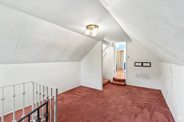 additional living space featuring carpet and vaulted ceiling