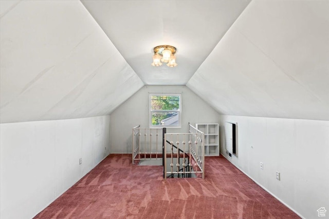 bonus room with carpet flooring and lofted ceiling