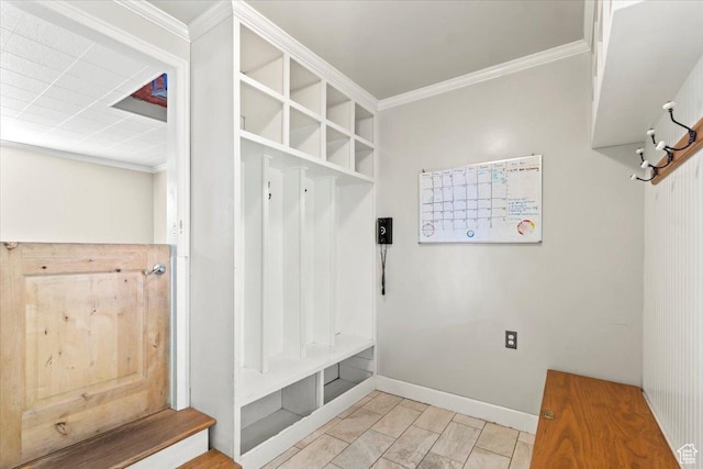 mudroom featuring ornamental molding, baseboards, and marble look tiles