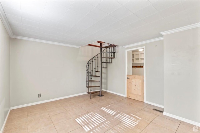 spare room featuring ornamental molding, stairway, tile patterned floors, and baseboards