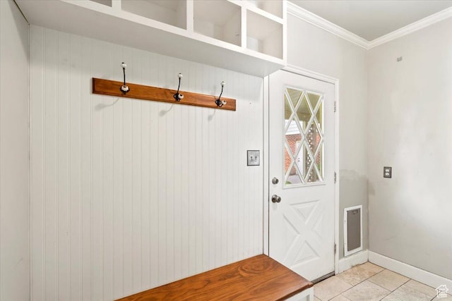 mudroom with ornamental molding, baseboards, and light tile patterned flooring