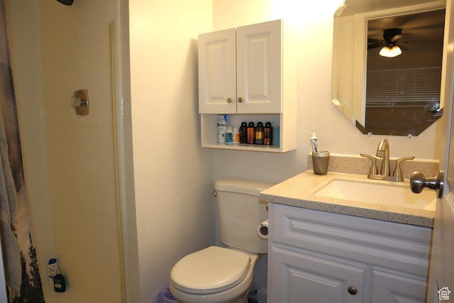 bathroom with a shower, toilet, vanity, and a ceiling fan