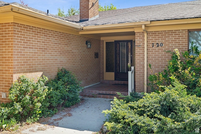 720 N 300 E, Tremonton, UT 84337 - view of exterior entry with brick siding, a chimney, and roof with shingles