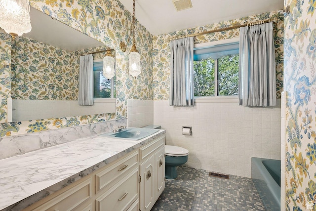 720 N 300 E, Tremonton, UT 84337 - bathroom with wallpapered walls, toilet, wainscoting, plenty of natural light, and vanity