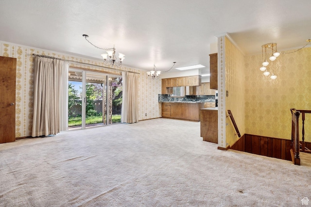 720 N 300 E, Tremonton, UT 84337 - unfurnished living room with wallpapered walls, a chandelier, and light colored carpet