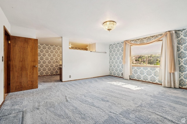 720 N 300 E, Tremonton, UT 84337 - empty room featuring carpet floors, wallpapered walls, and baseboards