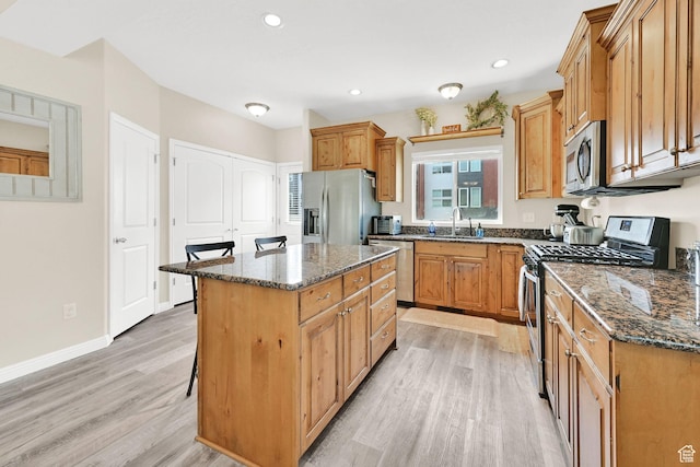 490 E 700 S Unit 514, Clearfield, UT 84015 - kitchen with stainless steel appliances, a sink, light wood-style flooring, dark stone counters, and recessed lighting