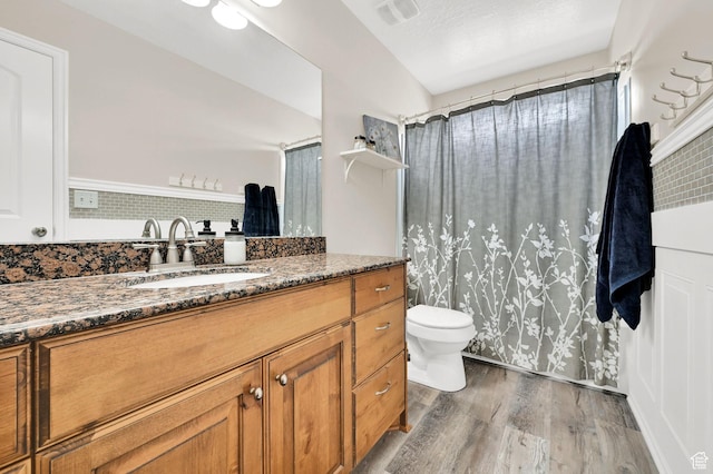 490 E 700 S Unit 514, Clearfield, UT 84015 - full bathroom featuring wood finished floors, toilet, vanity, and a shower with curtain