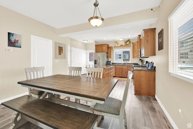 490 E 700 S Unit 514, Clearfield, UT 84015 - dining area with healthy amount of natural light, baseboards, and light wood finished floors