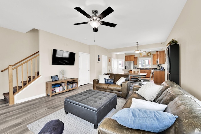 490 E 700 S Unit 514, Clearfield, UT 84015 - living area with light wood-type flooring, stairway, ceiling fan, and baseboards