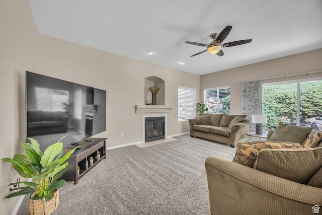 1828 W Woodview Dr, Lehi, UT 84043 - carpeted living room featuring baseboards, healthy amount of natural light, a fireplace with flush hearth, and a ceiling fan