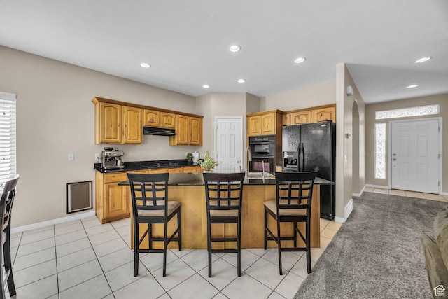 1828 W Woodview Dr, Lehi, UT 84043 - kitchen with under cabinet range hood, black appliances, light tile patterned floors, a breakfast bar area, and recessed lighting
