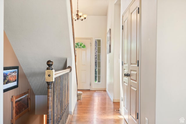8127 S Bear Lake Ct, West Jordan, UT 84081 - foyer entrance with light wood-type flooring and a chandelier
