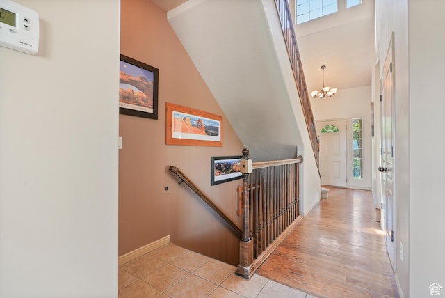 8127 S Bear Lake Ct, West Jordan, UT 84081 - hallway with an upstairs landing, plenty of natural light, baseboards, a chandelier, and vaulted ceiling