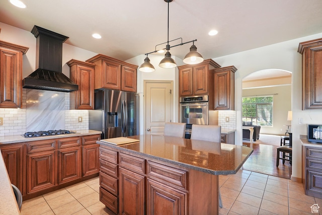 8127 S Bear Lake Ct, West Jordan, UT 84081 - kitchen with appliances with stainless steel finishes, wall chimney exhaust hood, arched walkways, light tile patterned floors, and recessed lighting