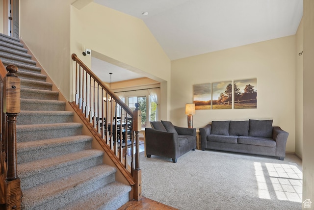 8127 S Bear Lake Ct, West Jordan, UT 84081 - carpeted living area with stairway and high vaulted ceiling