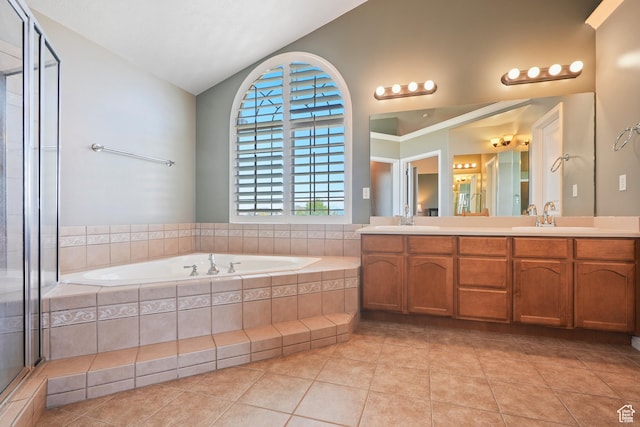8127 S Bear Lake Ct, West Jordan, UT 84081 - full bathroom with lofted ceiling, double vanity, a garden tub, and tile patterned flooring