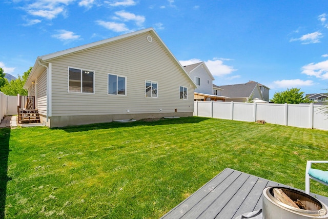 rear view of house featuring a fire pit