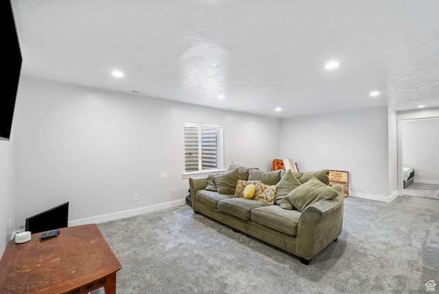 carpeted living room with recessed lighting, baseboards, and a textured ceiling