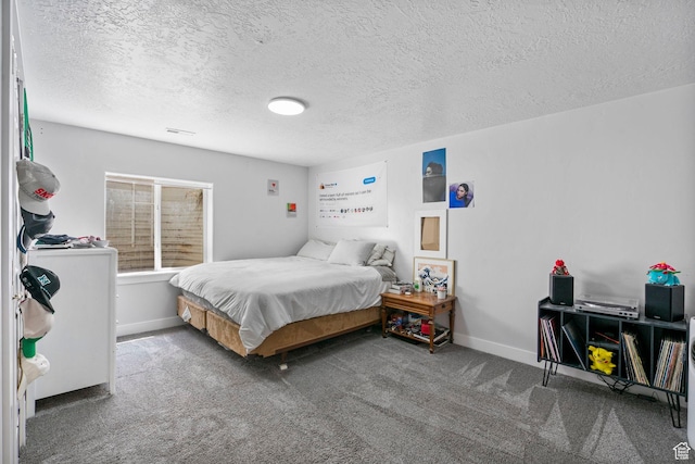 bedroom featuring carpet floors, a textured ceiling, and baseboards