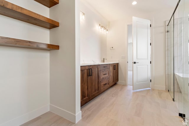4845 W 2020 S, Hurricane, UT 84737 - bathroom featuring a shower stall, baseboards, double vanity, and recessed lighting