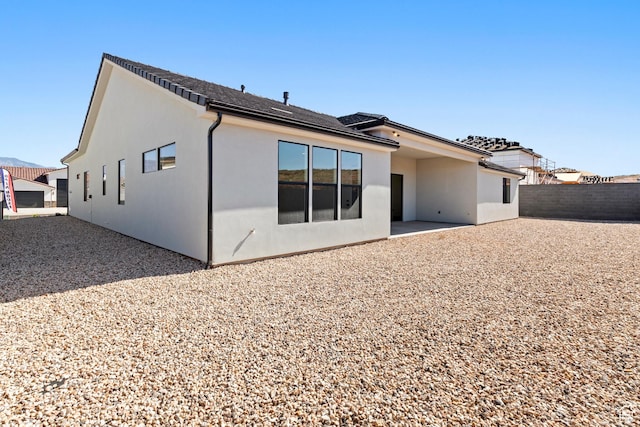 4845 W 2020 S, Hurricane, UT 84737 - rear view of property featuring stucco siding, fence, and a patio area